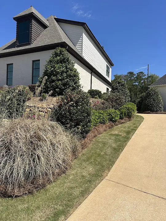 Maintained landscape beds and ornamental grasses along a home