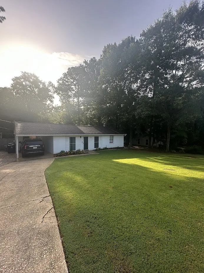 Clean, freshly serviced front yard at golden hour